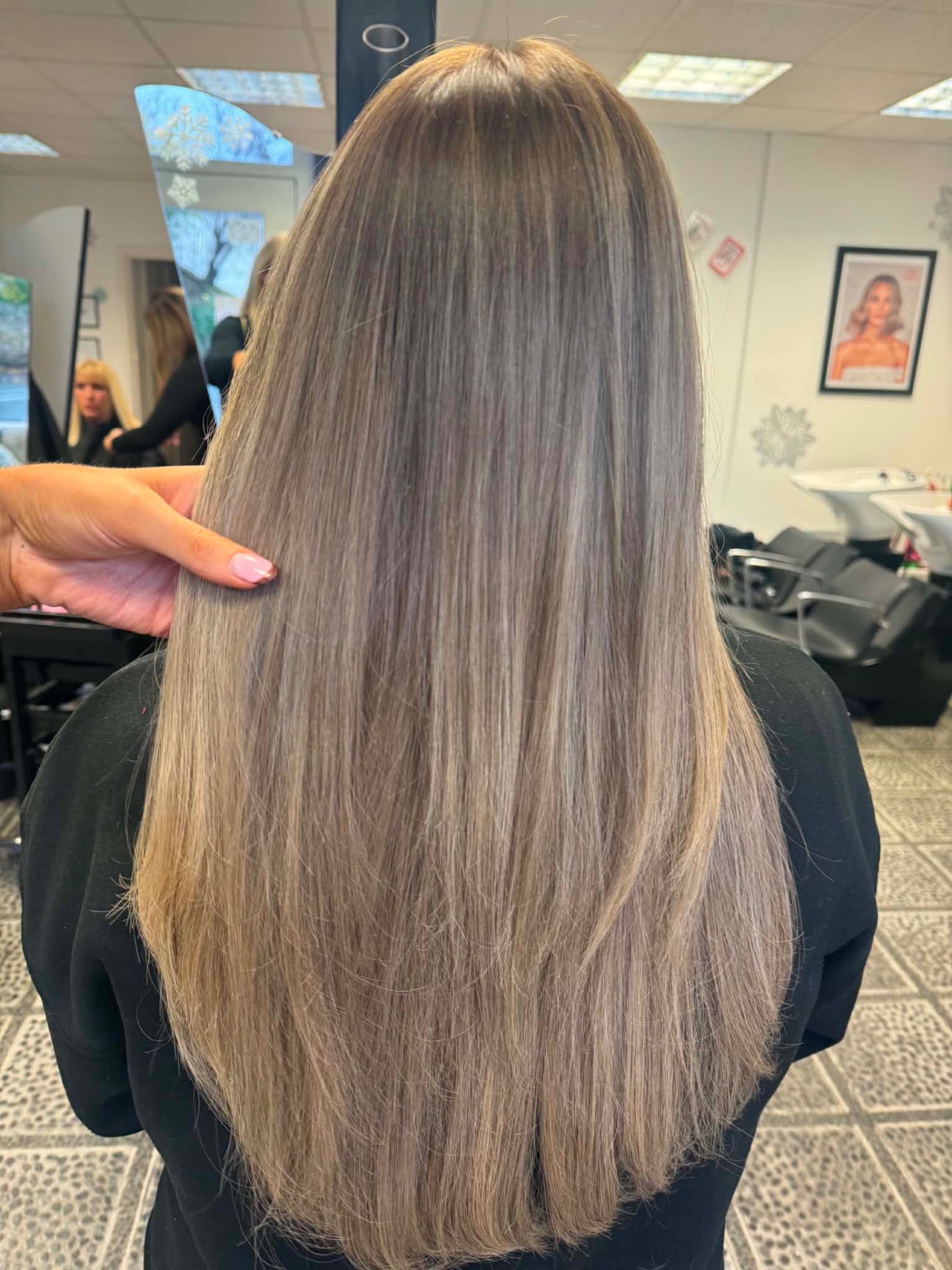 Long ash blonde hair styled smooth and straight
