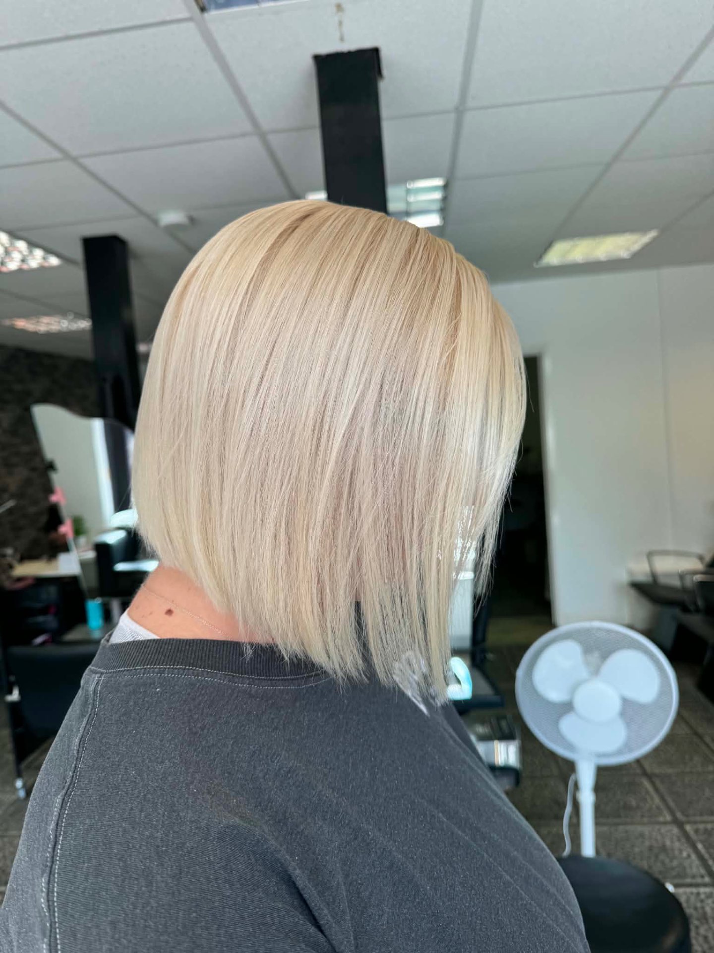 Bright blonde sharp bob styled sleek and straight