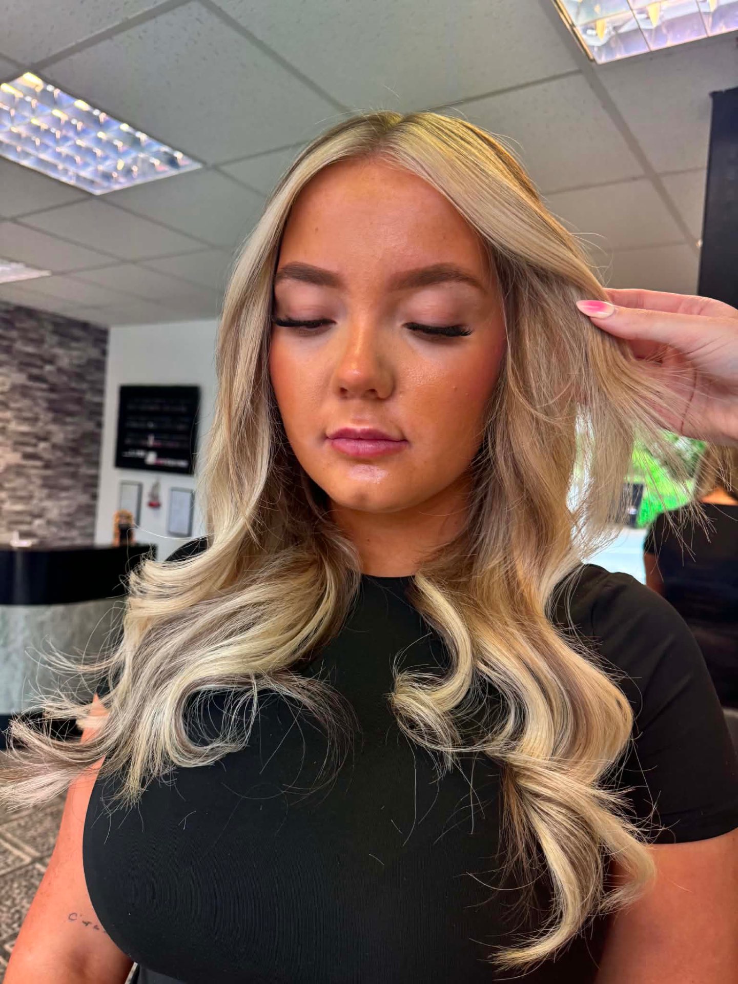 Blonde balayage styled with glam Hollywood waves