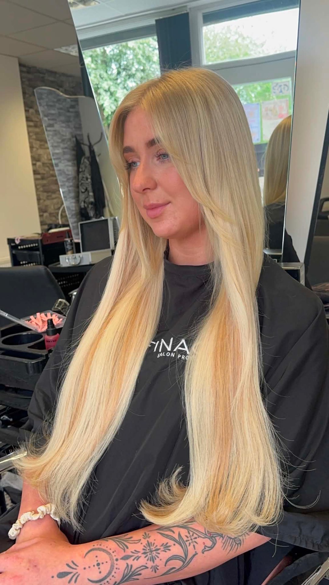 Long bright blonde hair styled smooth and straight