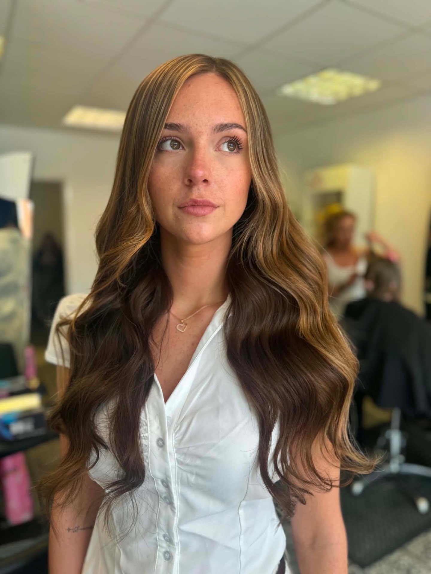 Long brunette hair with caramel highlights and big waves