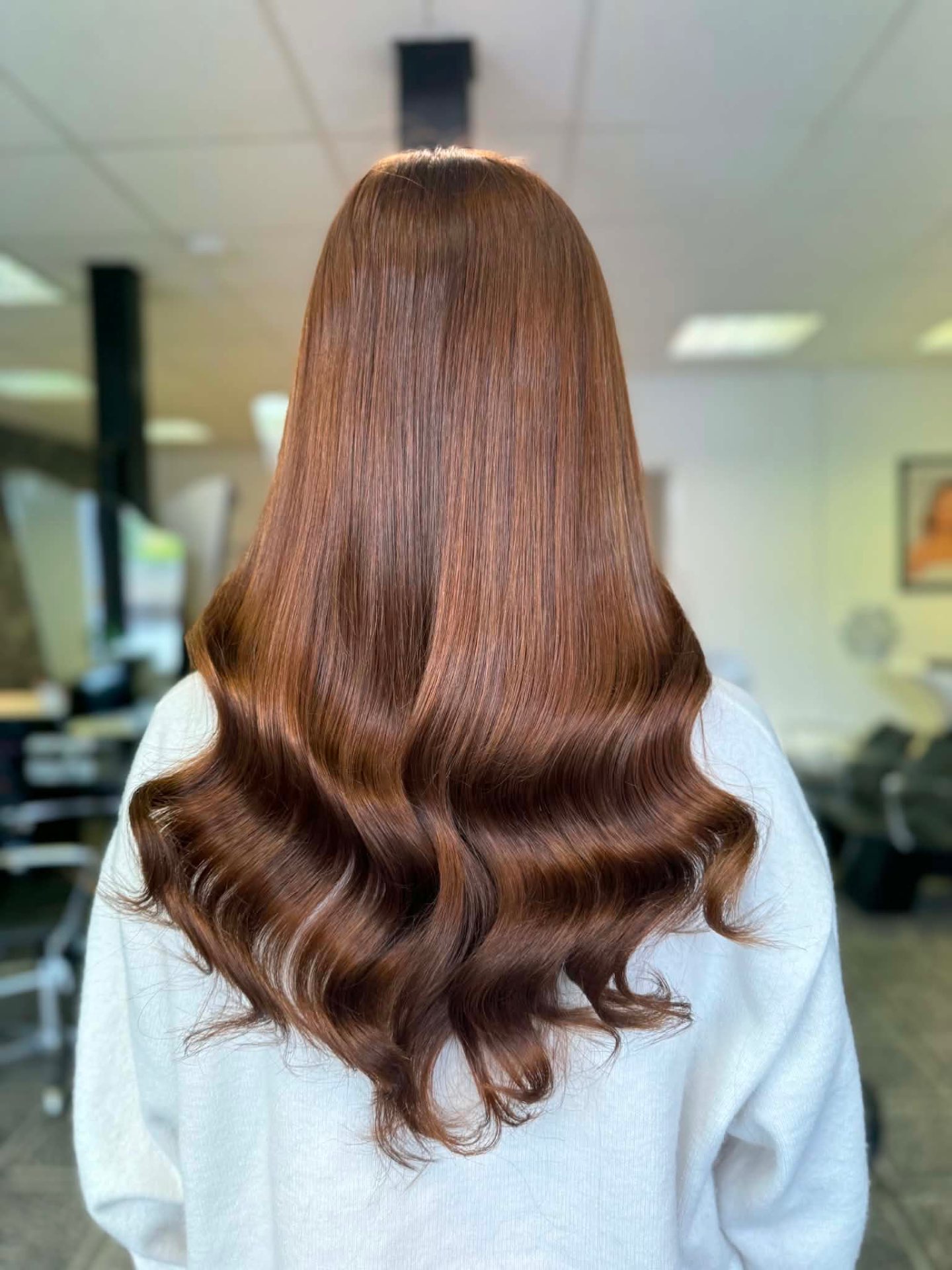 Long copper auburn hair with glossy Hollywood waves